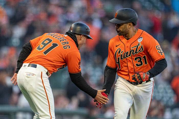 SF Giants first baseman LaMonte Wade Jr. (31) high fives San Francisco Giants third base coach Mark Hallberg (91) after hitting a solo home run against the Baltimore Orioles on June 2nd, 2023.